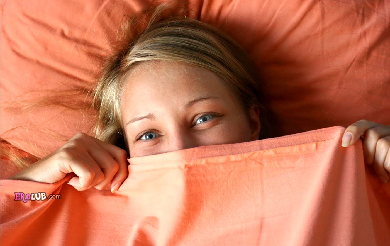 Голая молодая женщина с контрастным загаром в постели Голая молодая женщина с контрастным загаром в постели